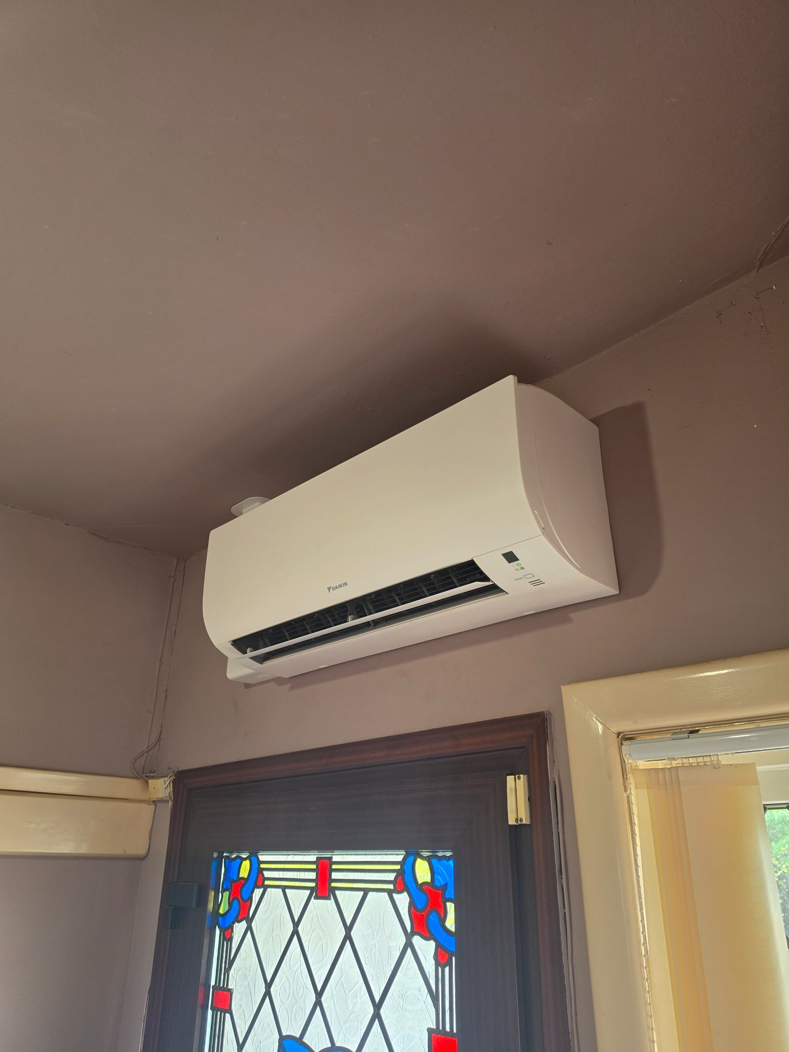 Wall mounted air conditioning unit fitted in the central hallway of a bungalow in North Petherton