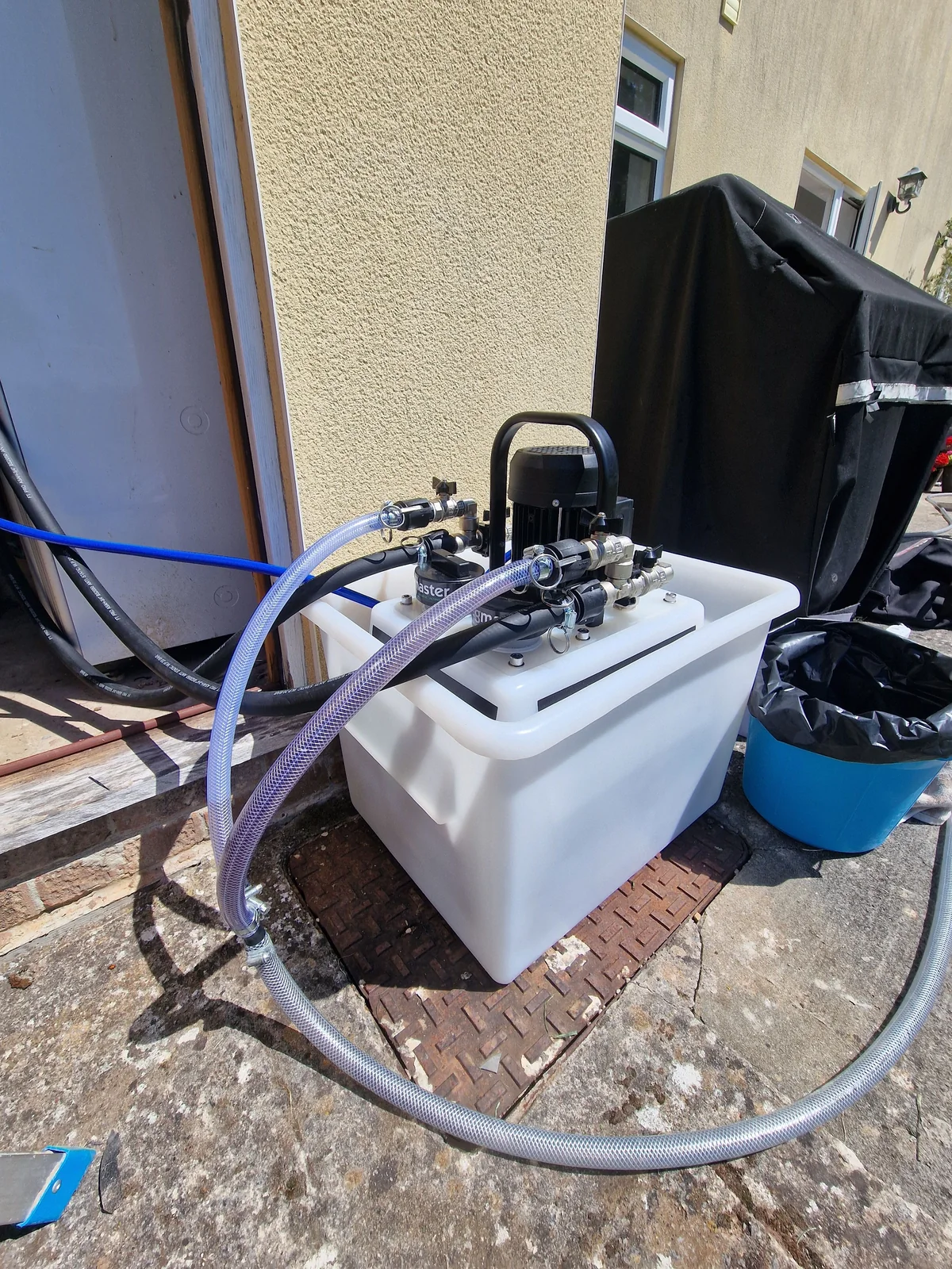 Close-up of the power-flushing pump and manifold connected to the customer's heating system